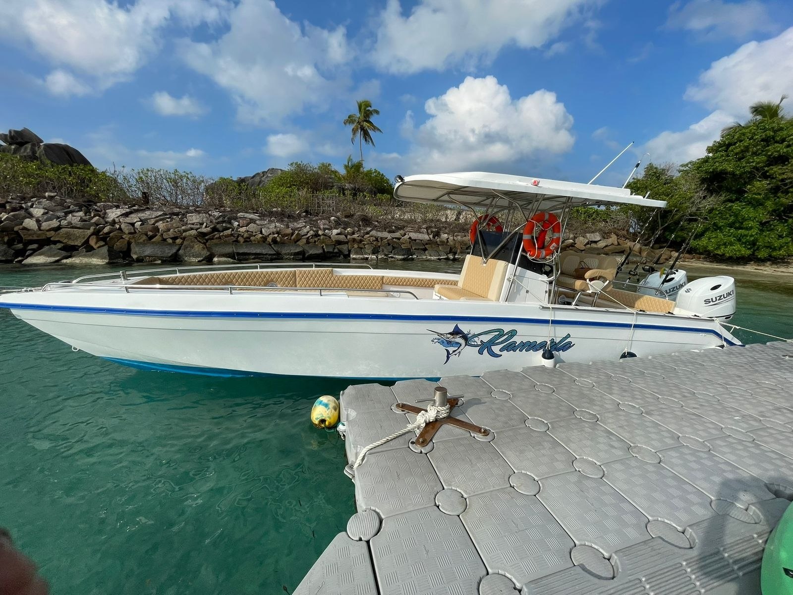 The Ramerla Charter boat moored alongside a floating pontoon in clear green water